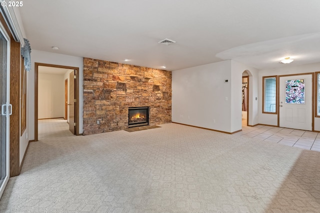 unfurnished living room featuring a fireplace and light carpet