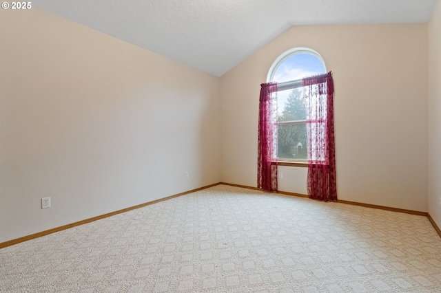 unfurnished room with light carpet and vaulted ceiling