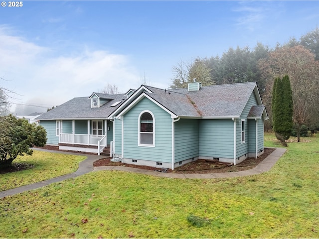 rear view of house with a porch and a lawn