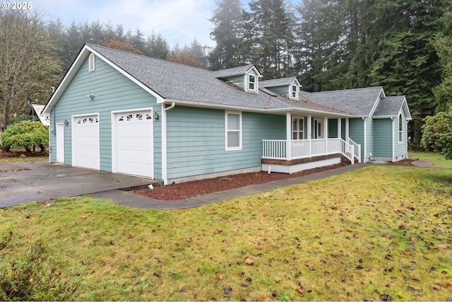 view of front of home featuring a porch, a garage, and a front lawn