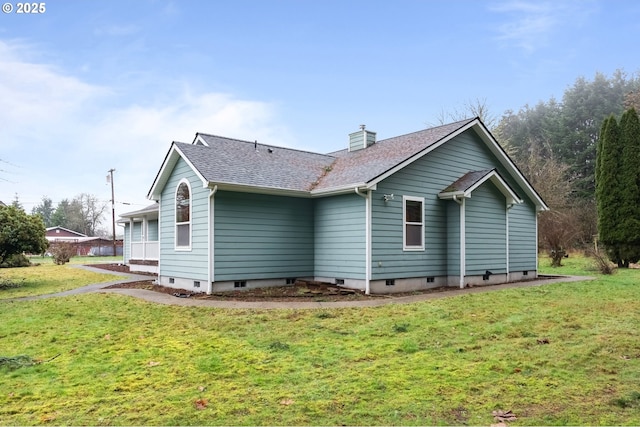 rear view of property with a yard