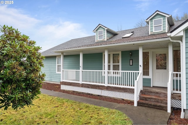 cape cod house featuring covered porch