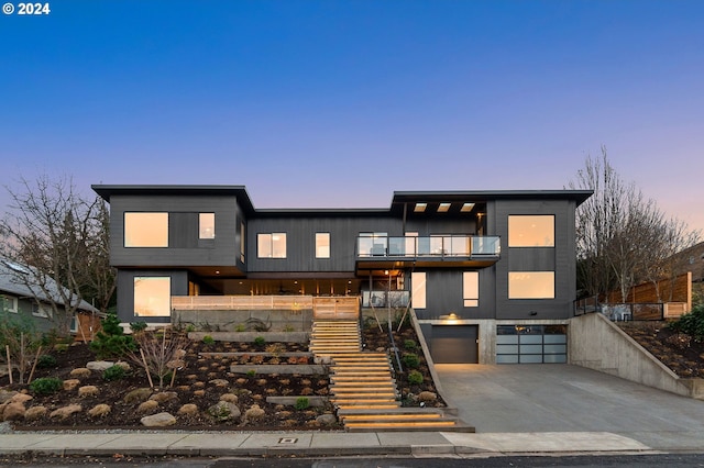 modern home with a garage and a balcony