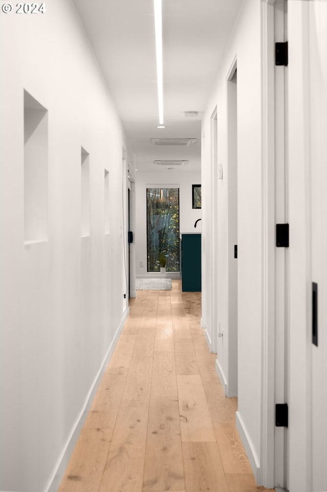 hall with light hardwood / wood-style flooring