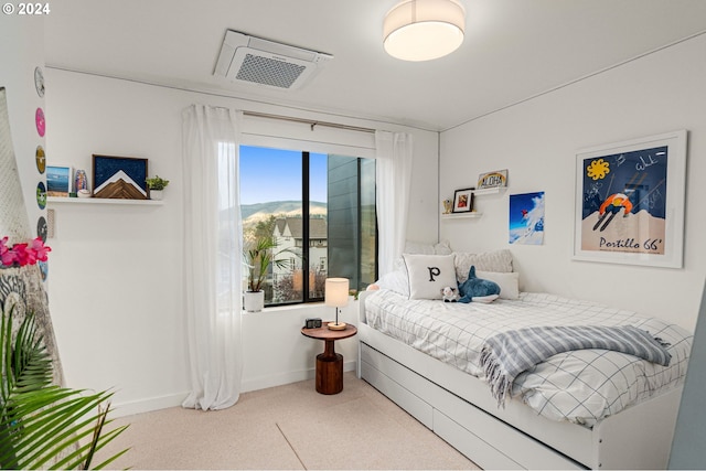 bedroom featuring a mountain view and carpet