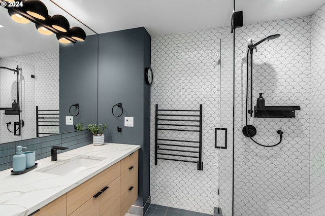 bathroom featuring vanity, decorative backsplash, and a shower with shower door