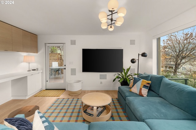 living room with a notable chandelier and light wood-type flooring