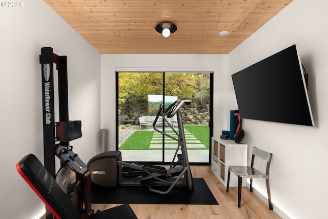 workout room with vaulted ceiling, light wood-type flooring, and wooden ceiling