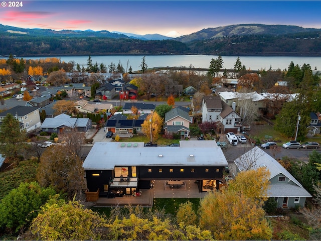 aerial view at dusk with a water and mountain view