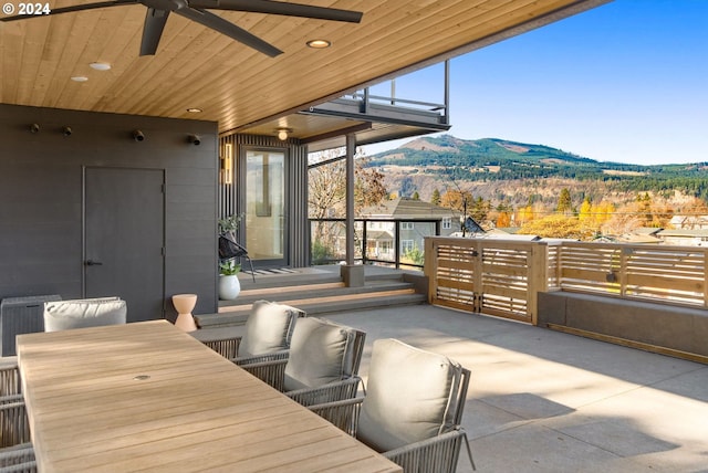 view of patio with ceiling fan, an outdoor hangout area, and a mountain view