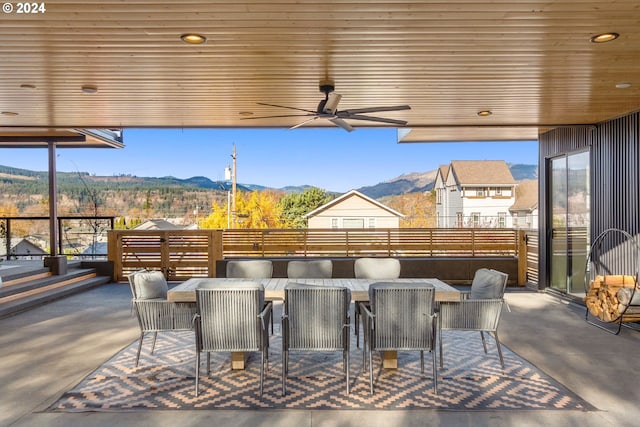 view of patio / terrace featuring a mountain view, ceiling fan, and exterior bar