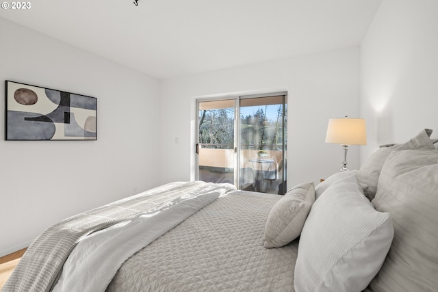 bedroom with light hardwood / wood-style floors and access to exterior