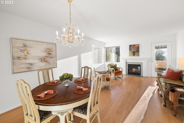 dining space featuring an inviting chandelier and light wood-type flooring