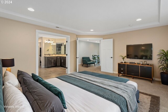 carpeted bedroom with an inviting chandelier and connected bathroom