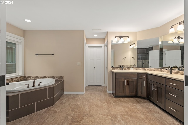 bathroom with vanity and shower with separate bathtub