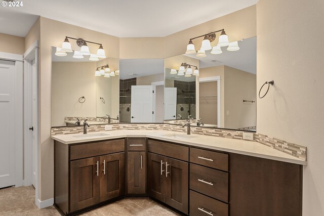 bathroom with tile patterned flooring, backsplash, and vanity