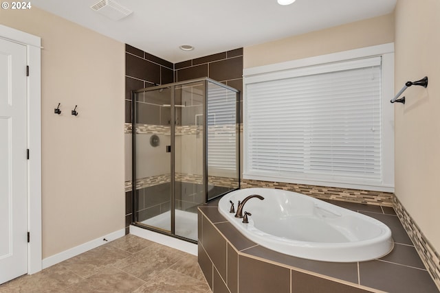 bathroom with independent shower and bath and tile patterned floors