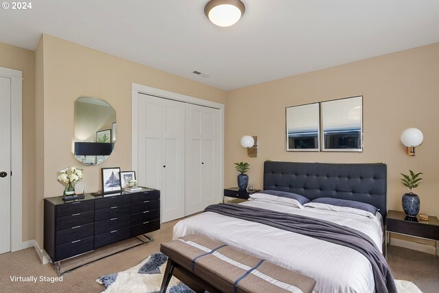 bedroom featuring light carpet and a closet