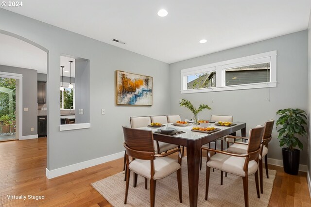 dining space with a wealth of natural light and light hardwood / wood-style flooring