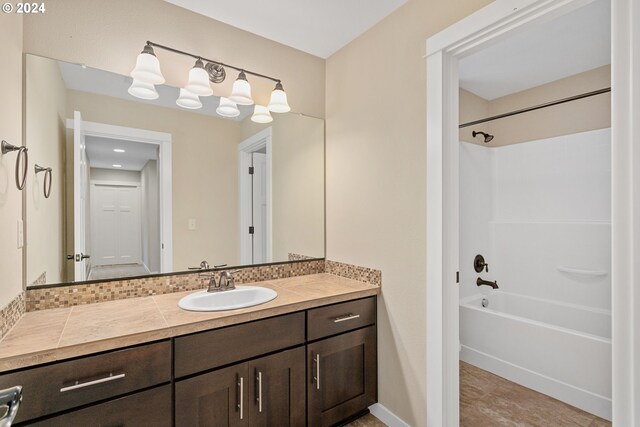 bathroom with vanity and shower / washtub combination