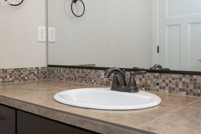 bathroom featuring decorative backsplash and vanity