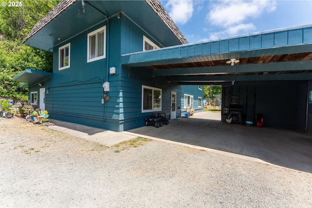 93777 Green Acres Ln, Coos Bay, OR 97420 - view of side of home featuring an attached carport and dirt driveway