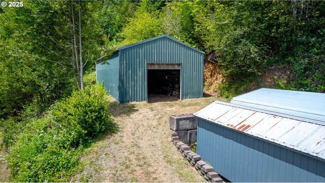 93777 Green Acres Ln, Coos Bay, OR 97420 - view of outbuilding featuring a wooded view