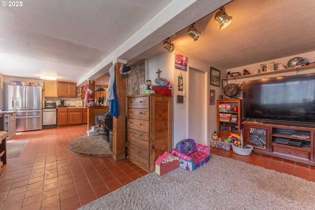 93777 Green Acres Ln, Coos Bay, OR 97420 - living area featuring tile patterned floors, a textured ceiling, and a wood stove