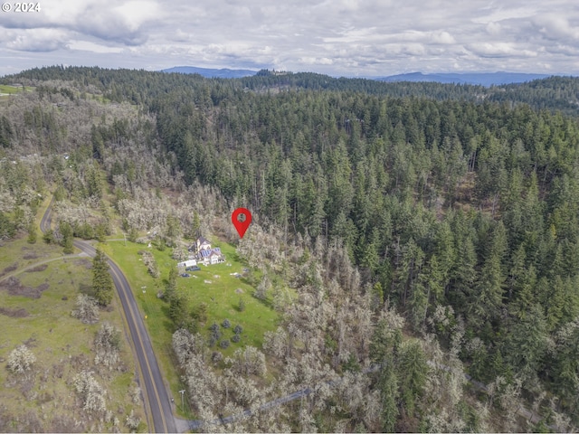 drone / aerial view featuring a forest view