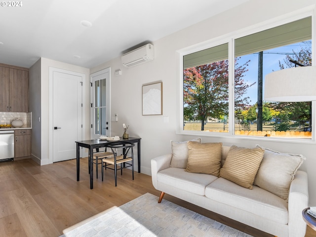 living room with light wood-type flooring and a wall unit AC