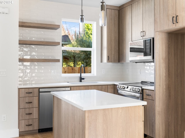 kitchen with a center island, tasteful backsplash, sink, hanging light fixtures, and stainless steel appliances