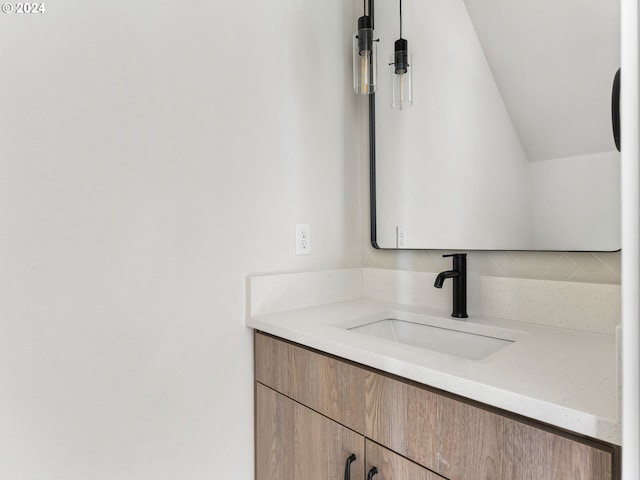 bathroom featuring vanity and vaulted ceiling