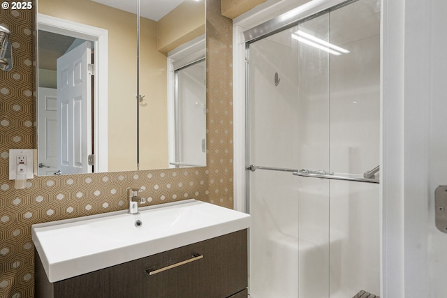 bathroom featuring vanity and tasteful backsplash