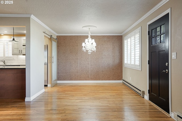 unfurnished dining area featuring a healthy amount of sunlight, light wood-type flooring, and a baseboard heating unit