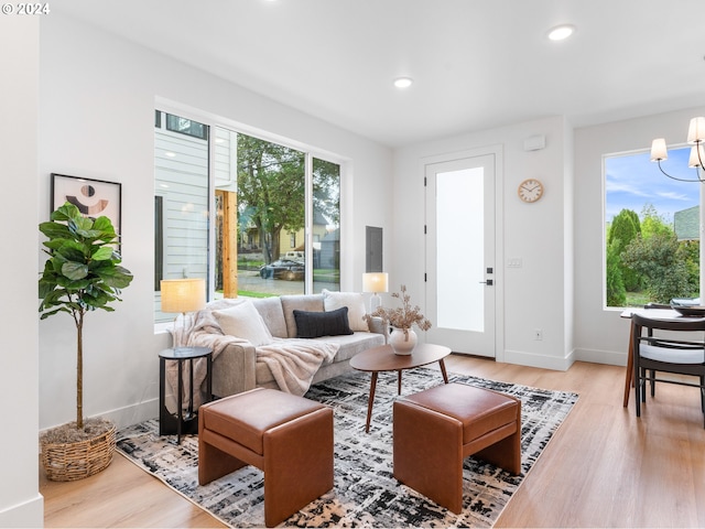 living room featuring hardwood / wood-style floors, a chandelier, and plenty of natural light