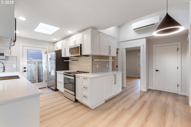 kitchen featuring white cabinets, backsplash, stainless steel appliances, and a wall unit AC