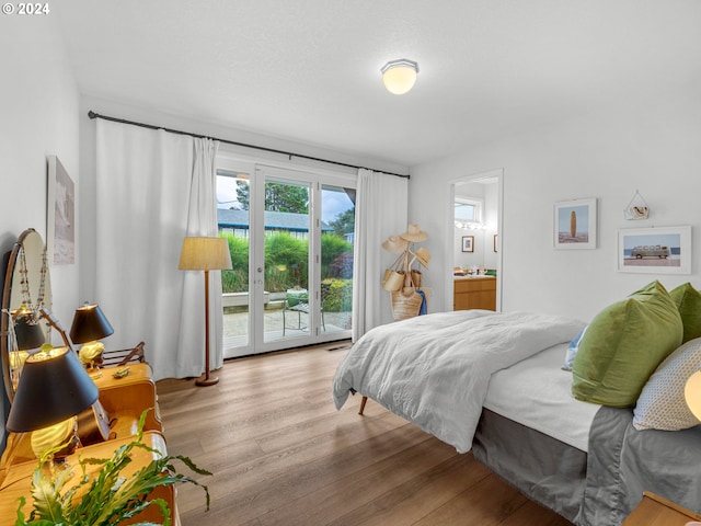 bedroom featuring access to exterior, connected bathroom, and light hardwood / wood-style floors