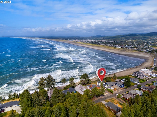 drone / aerial view with a beach view and a water view