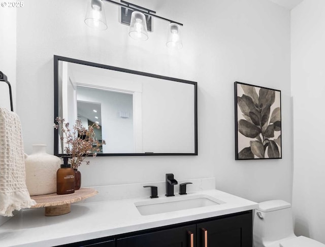 bathroom featuring toilet and vanity