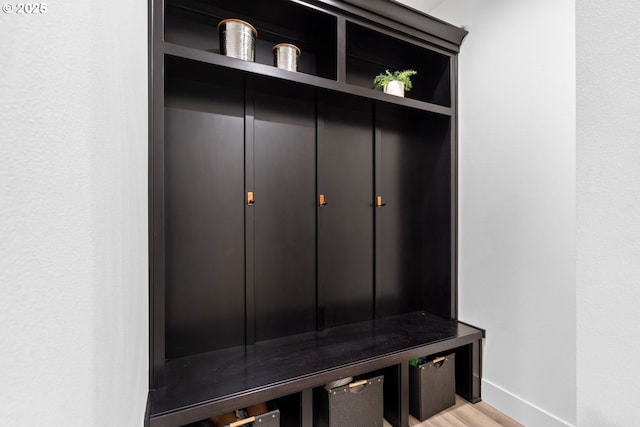 mudroom with baseboards and light wood-style flooring