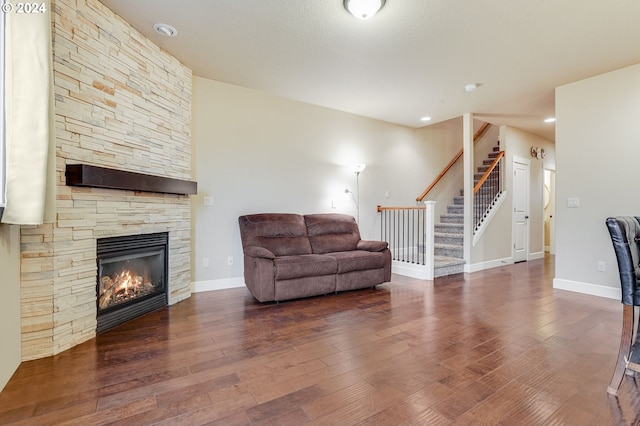 living room with a fireplace and dark hardwood / wood-style floors