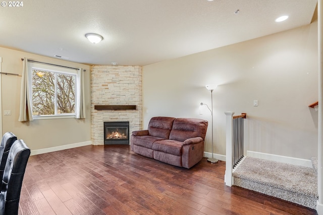 living room featuring a fireplace and dark hardwood / wood-style floors