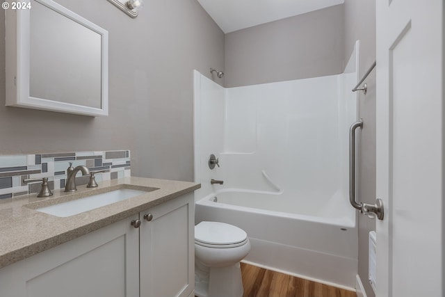 full bathroom with tasteful backsplash, hardwood / wood-style floors, shower / bathing tub combination, vanity, and toilet