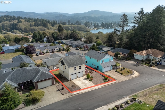 birds eye view of property featuring a water and mountain view