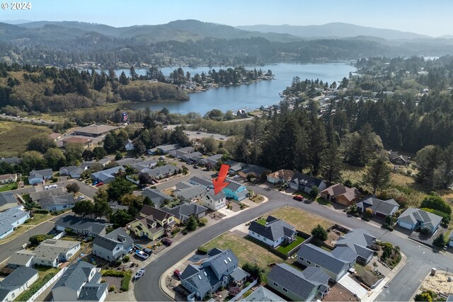 birds eye view of property with a water and mountain view