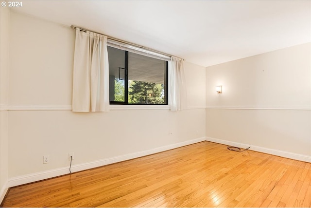 spare room with light hardwood / wood-style floors