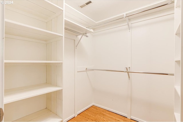 walk in closet featuring hardwood / wood-style flooring