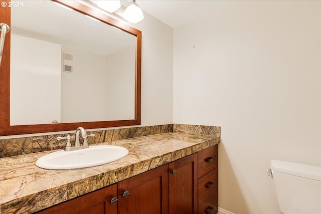 bathroom with vanity and toilet