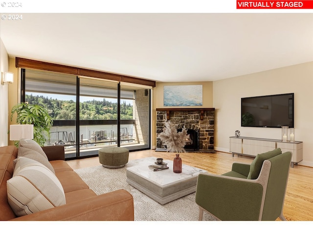 living room with a fireplace, hardwood / wood-style floors, and expansive windows