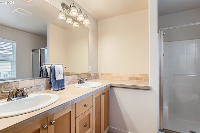 bathroom featuring vanity and a shower with door